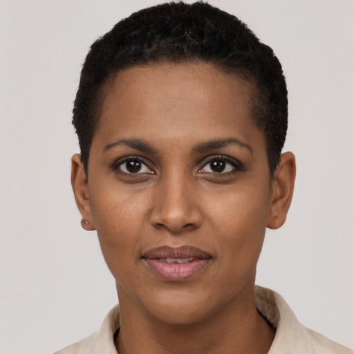Joyful black young-adult female with short  black hair and brown eyes