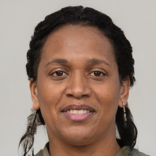 Joyful black adult female with short  black hair and brown eyes