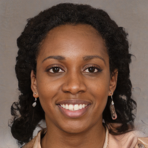 Joyful black young-adult female with medium  brown hair and brown eyes