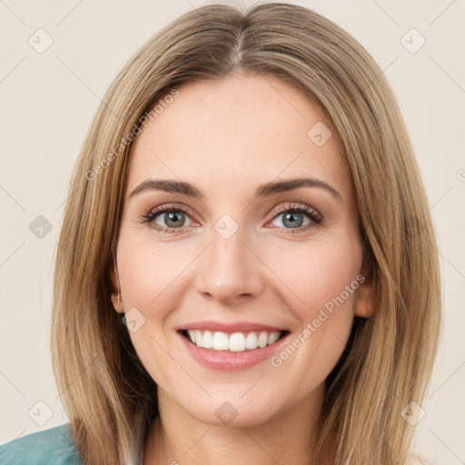 Joyful white young-adult female with medium  brown hair and green eyes