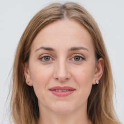 Joyful white young-adult female with long  brown hair and grey eyes