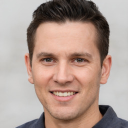 Joyful white adult male with short  brown hair and brown eyes