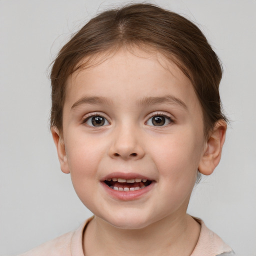 Joyful white child female with short  brown hair and brown eyes