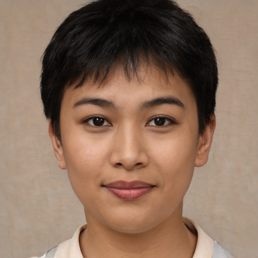 Joyful asian young-adult female with short  brown hair and brown eyes