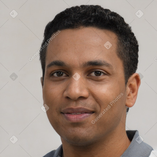 Joyful black young-adult male with short  black hair and brown eyes