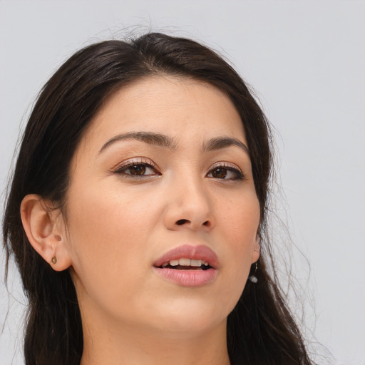 Joyful asian young-adult female with long  brown hair and brown eyes