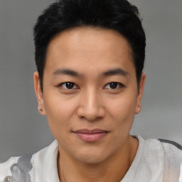 Joyful asian young-adult male with short  black hair and brown eyes