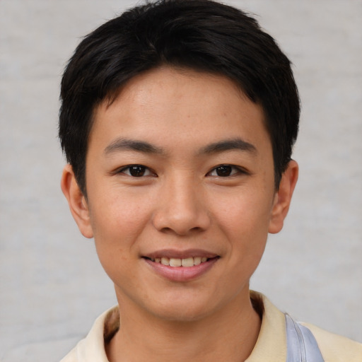 Joyful asian young-adult male with short  brown hair and brown eyes
