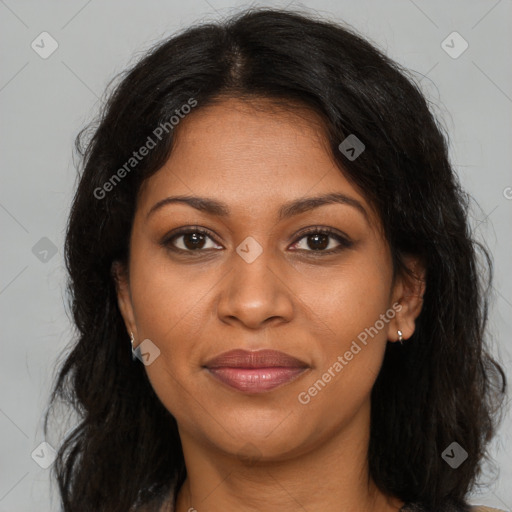 Joyful black young-adult female with long  brown hair and brown eyes