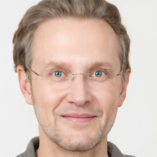 Joyful white adult male with short  brown hair and grey eyes