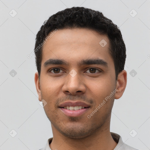 Joyful latino young-adult male with short  black hair and brown eyes