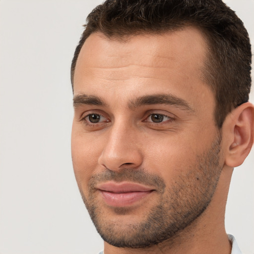 Joyful white young-adult male with short  brown hair and brown eyes