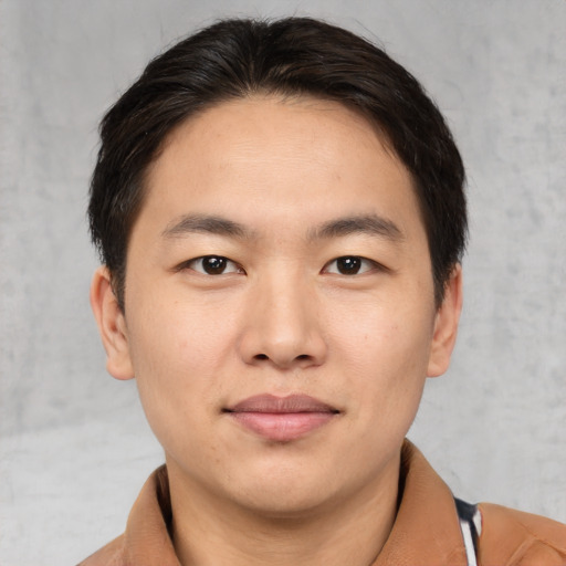 Joyful asian young-adult male with medium  brown hair and brown eyes
