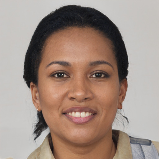Joyful black young-adult female with short  brown hair and brown eyes