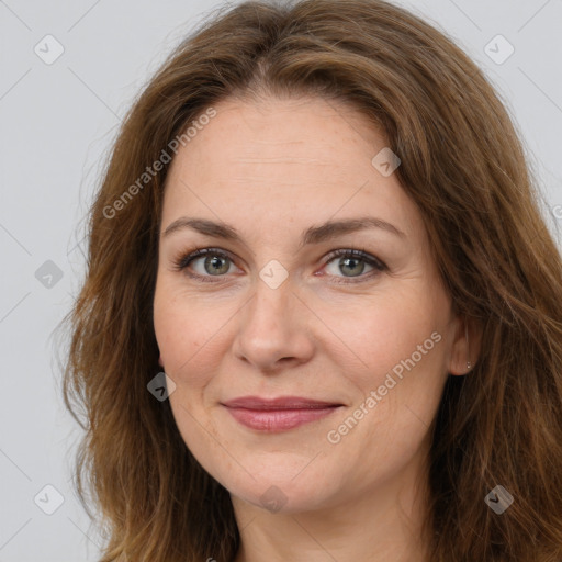 Joyful white adult female with long  brown hair and brown eyes