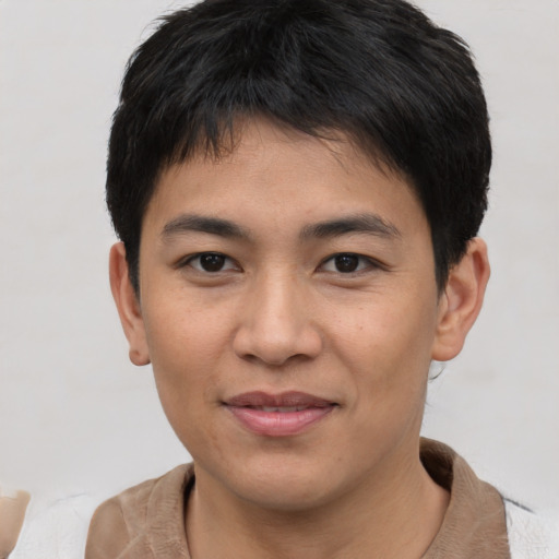 Joyful asian young-adult male with short  brown hair and brown eyes