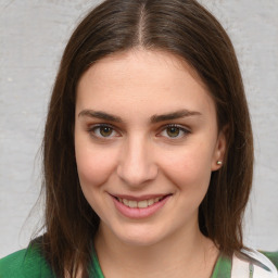 Joyful white young-adult female with medium  brown hair and green eyes