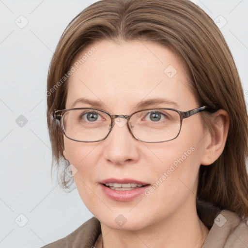 Joyful white adult female with medium  brown hair and blue eyes