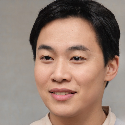 Joyful asian young-adult male with short  brown hair and brown eyes