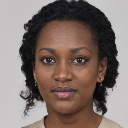 Joyful black young-adult female with medium  black hair and brown eyes
