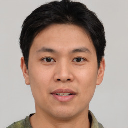 Joyful asian young-adult male with short  brown hair and brown eyes