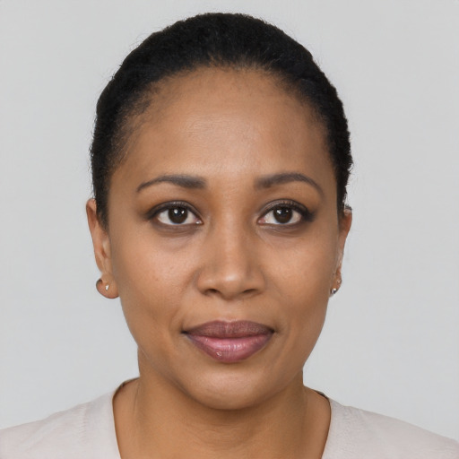 Joyful black young-adult female with short  black hair and brown eyes