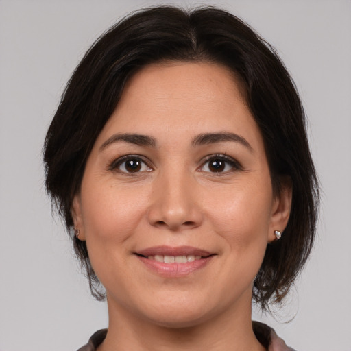 Joyful white young-adult female with medium  brown hair and brown eyes