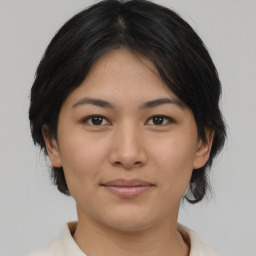 Joyful asian young-adult female with medium  black hair and brown eyes