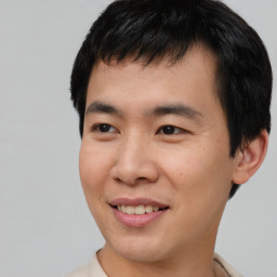 Joyful asian young-adult male with short  black hair and brown eyes