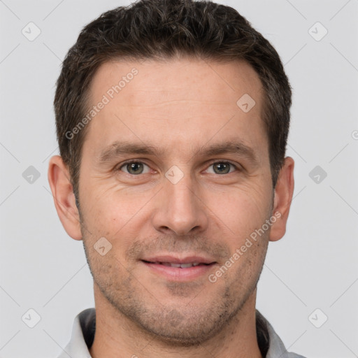 Joyful white adult male with short  brown hair and brown eyes