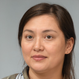 Joyful white adult female with medium  brown hair and brown eyes