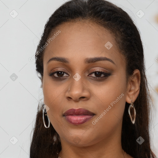 Joyful black young-adult female with long  brown hair and brown eyes