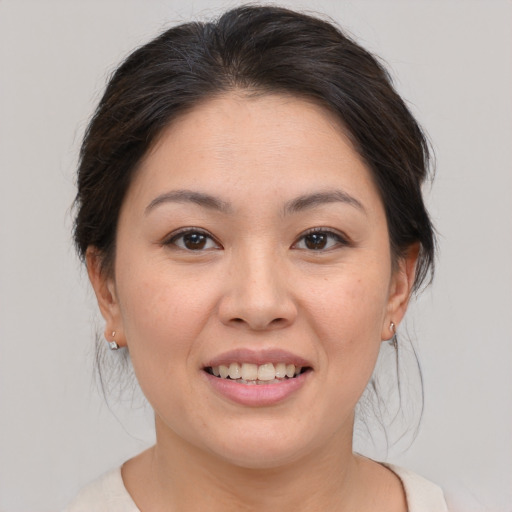 Joyful white young-adult female with medium  brown hair and brown eyes