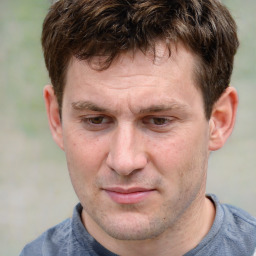 Joyful white adult male with short  brown hair and grey eyes