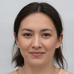 Joyful white young-adult female with medium  brown hair and brown eyes