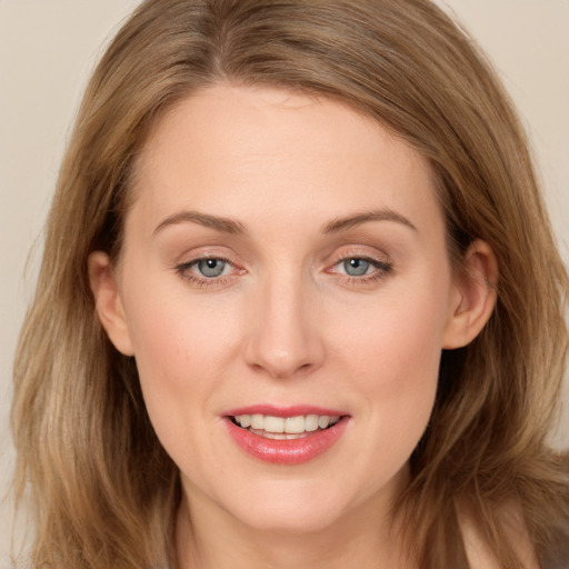 Joyful white young-adult female with long  brown hair and grey eyes