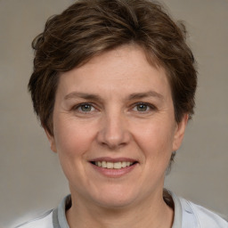 Joyful white adult female with short  brown hair and brown eyes