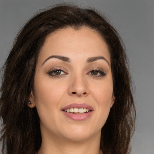 Joyful white young-adult female with long  brown hair and brown eyes