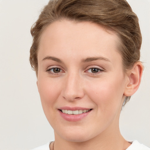 Joyful white young-adult female with short  brown hair and grey eyes