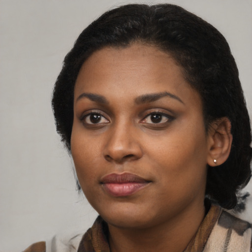 Joyful black young-adult female with medium  black hair and brown eyes