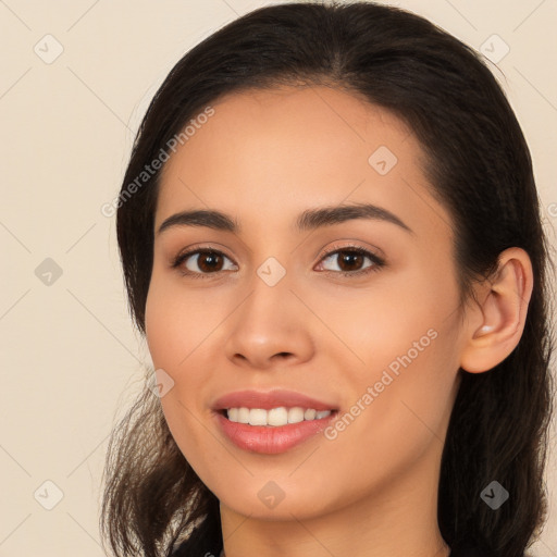 Joyful latino young-adult female with long  brown hair and brown eyes