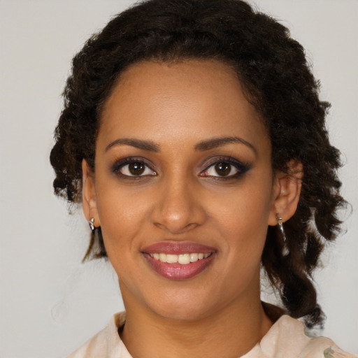 Joyful black young-adult female with medium  brown hair and brown eyes