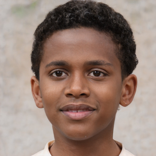 Joyful black child male with short  brown hair and brown eyes