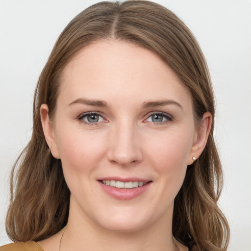 Joyful white young-adult female with medium  brown hair and blue eyes