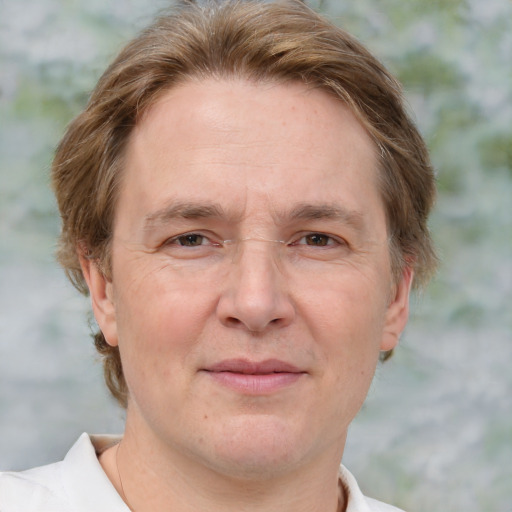 Joyful white adult male with short  brown hair and blue eyes