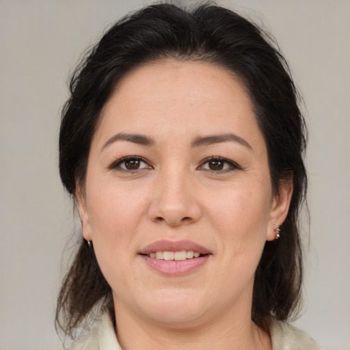 Joyful white adult female with medium  brown hair and brown eyes