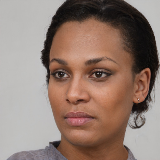 Neutral black young-adult female with medium  brown hair and brown eyes