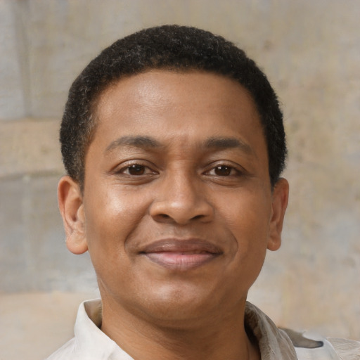 Joyful latino young-adult male with short  brown hair and brown eyes