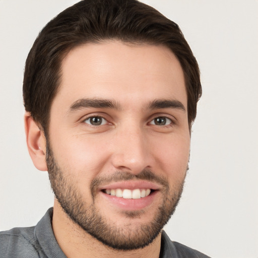 Joyful white young-adult male with short  brown hair and brown eyes