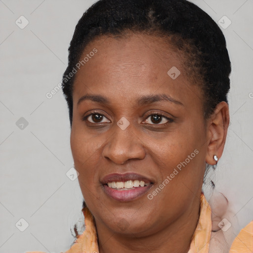 Joyful black adult female with short  brown hair and brown eyes